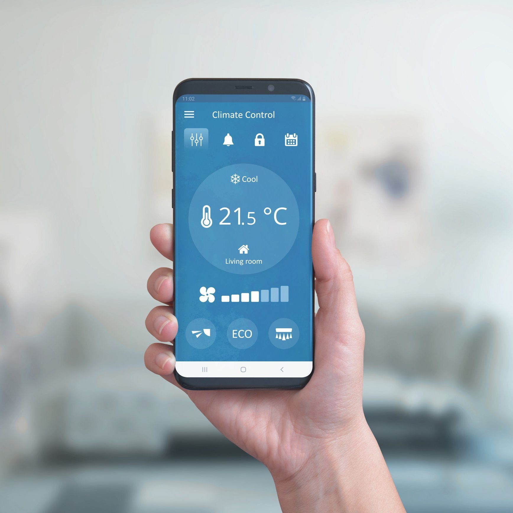 Smart phone in hand with climate control app. Concept of environmental comfort automation with a simple phone app.