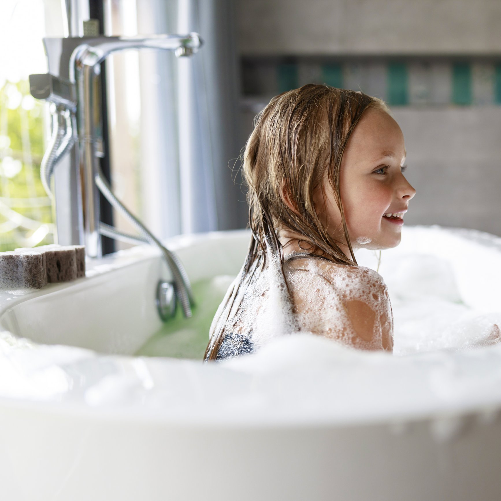 Smiling girl looking away in the bathroom
